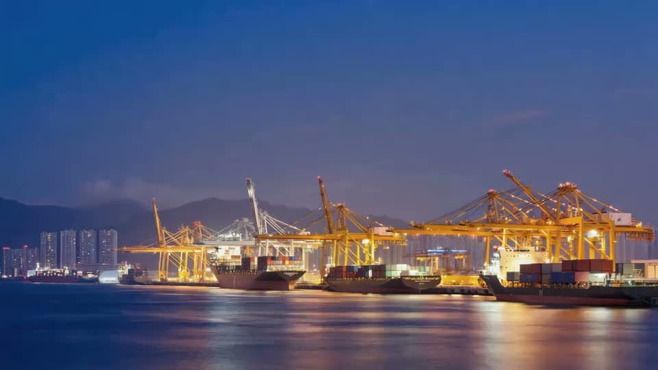 Container port at night with illuminated cranes